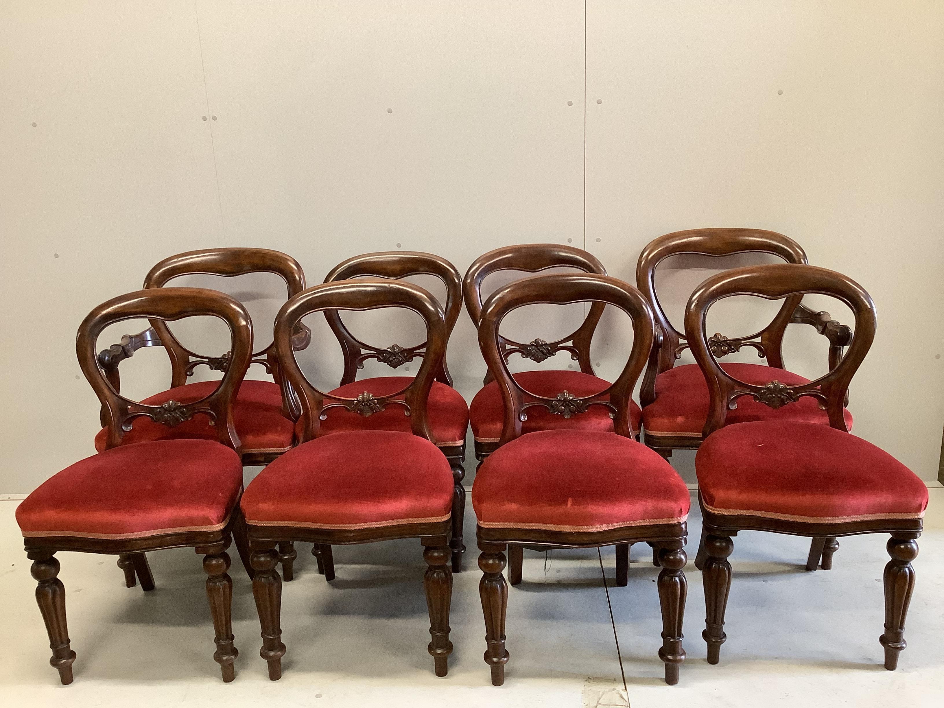 A set of eight Victorian style mahogany balloon back dining chairs, two with arms